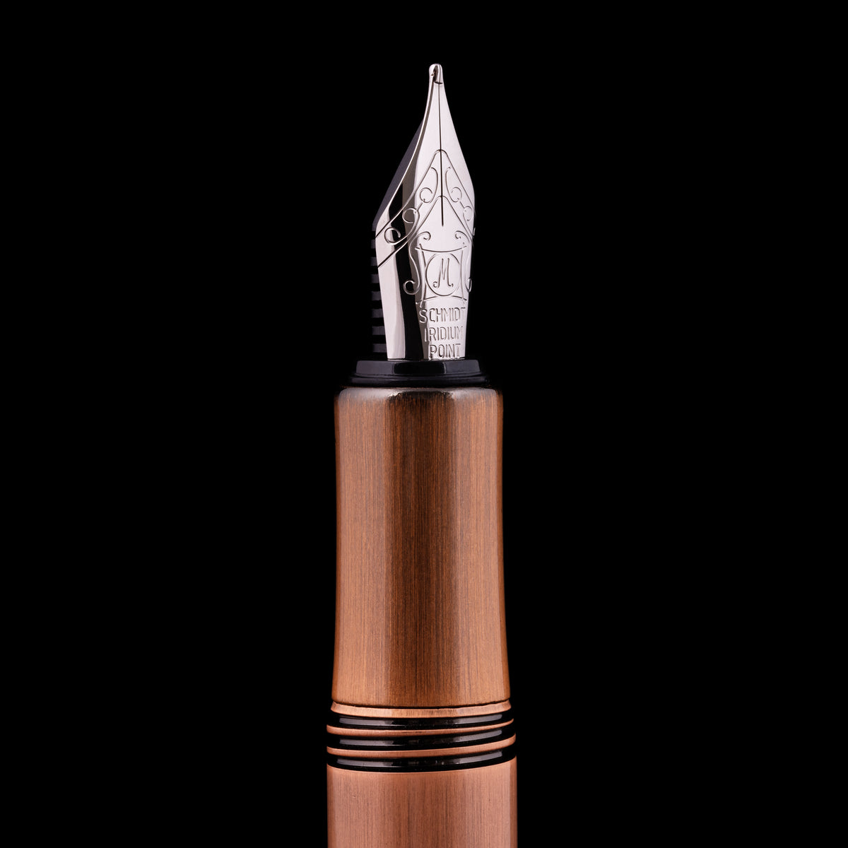 Fountain pen with wooden barrel and silver nib on a black background